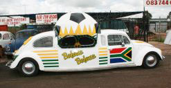 A giant football and pair of sunglasses adorn the white Beetle