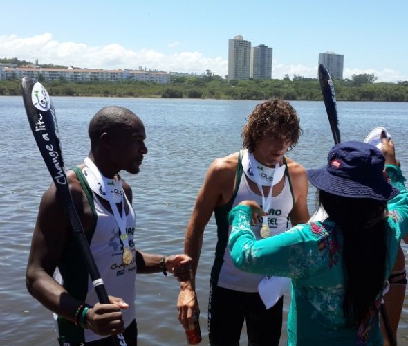 dusi Sbonelo Zondi and Andy Birkett receive their gold medals from the MEC for art, culture, sport and recreation, Ntombikayise Sibhidla-Saphetha, at the finish of the 2014 Dusi Canoe Marathon at Blue Lagoon in Durban. (Image: Lucille Davie)