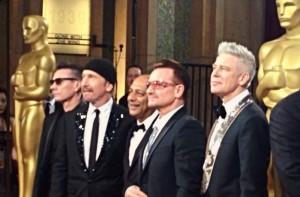 Anant Singh (centre) with U2 at the Oscars earlier this month. U2 were nominated for the film's song 'Ordinary Love'