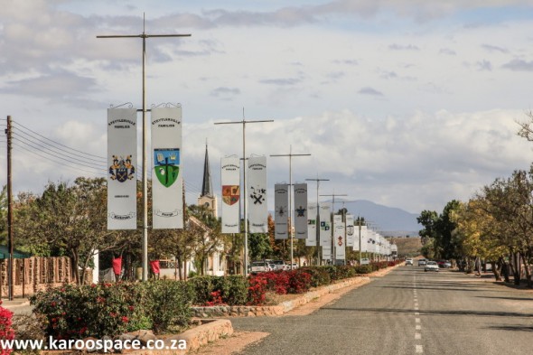 The hoisted family crests of the people of Steytlerville in the main street.