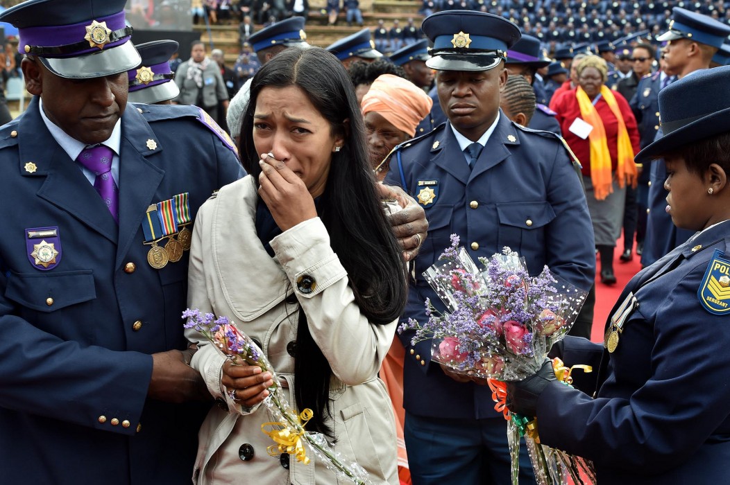 Family members of police who died on duty lay wreaths in remembrance of their loved ones during the South Africa Police Service Commemoration Day Family members of police who died on duty lay wreaths in remembrance of their loved ones during the South Africa Police Service Commemoration Day