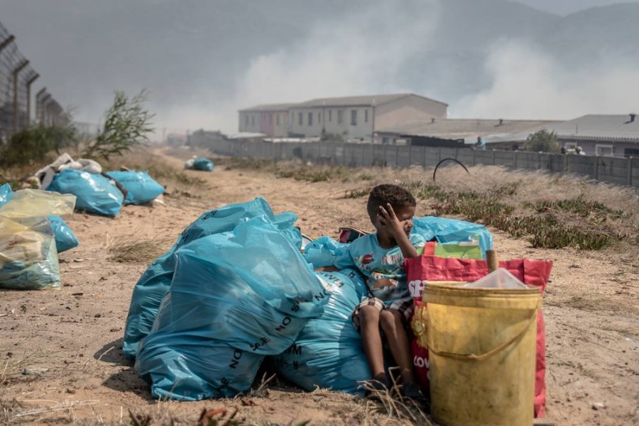 Young boy wipes eye Cape Fires, South Africa