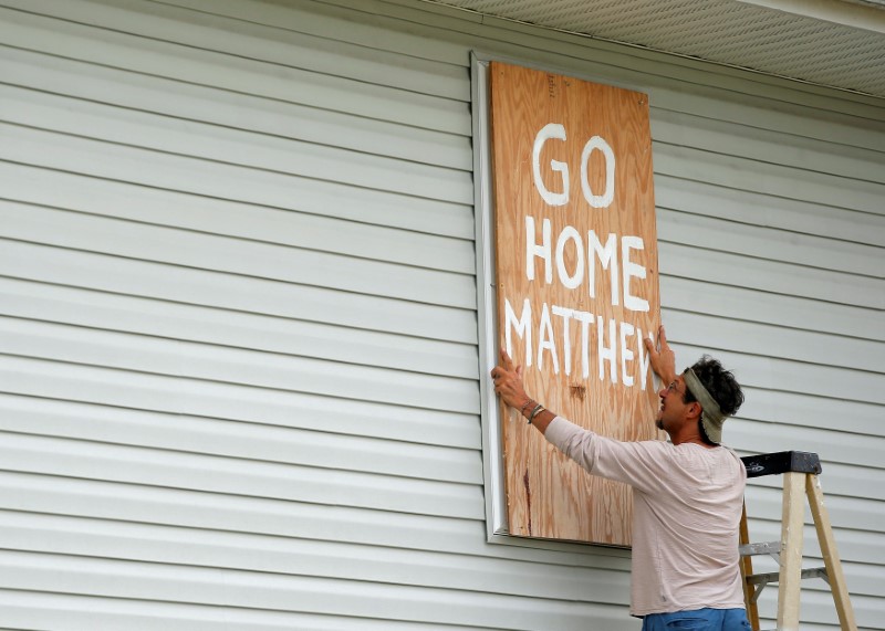Homeowner Don Appell prepares to board up one of the windows at his home ahead of Hurricane Matthew in Cherry Grove, South Carolina, U.S. October 6, 2016. REUTERS/Chris Keane