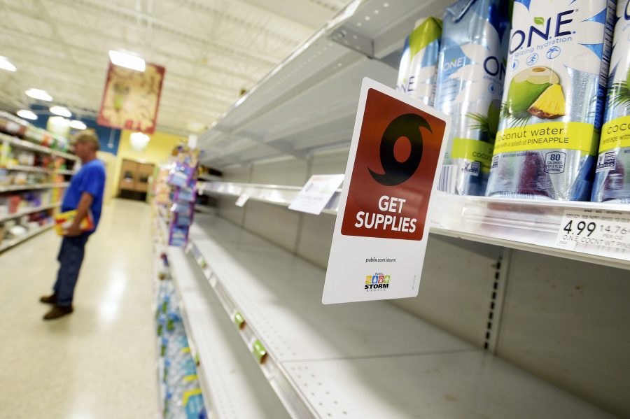 Shelves formerly holding water bottles sit empty at a supermarket before the arrival of Hurricane Matthew in South Daytona, Florida, U.S., Oct. 6, 2016. REUTERS/Phelan Ebenhack