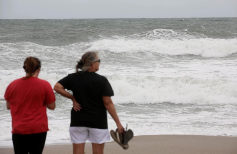 People look out at the sea as while Hurricane Matthew approaches in Melbourne, Florida, U.S. October 6, 2016. REUTERS/Henry Romero