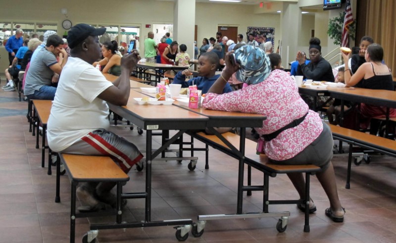 Residents eat at a school being used as a shelter while Hurricane Matthew approaches in Melbourne, Florida, U.S. October 6, 2016. REUTERS/Henry Romero