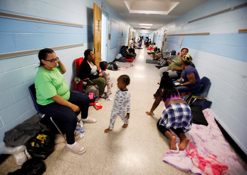 Residents of Charleston occupy a school hallway at a shelter ahead of the arrival of Hurricane Matthew, in North Charleston, South Carolina October 6, 2016. REUTERS/Jonathan Drake
