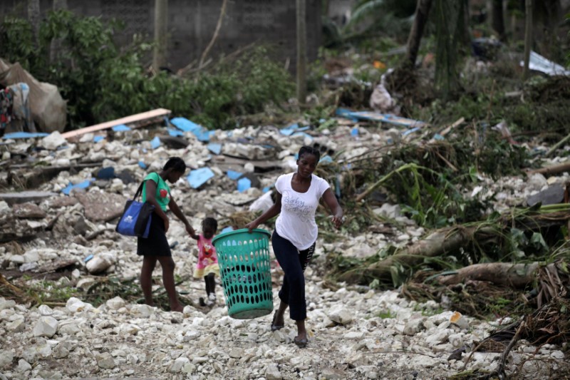 A woman carries a laundry basket in an area devastated by Hurricane Matthew in Cavaillon, Haiti, October 6, 2016. REUTERS/Andres Martinez Casares
