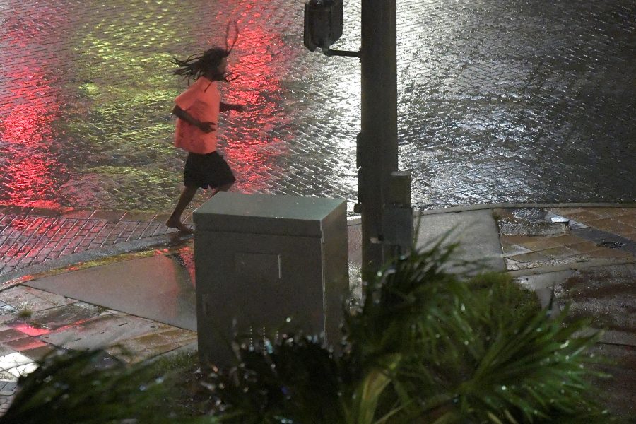 A pedestrian runs across a street as the eye of Hurricane Matthew approaches Daytona Beach, Florida, U.S. October 7, 2016.  REUTERS/Phelan Ebenhack