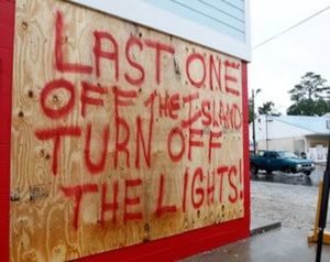 A car passes a sign posted as some people evacuate due to Hurricane Matthew on Tybee Island, Georgia, October 7, 2016. REUTERS/Tami Chappell
