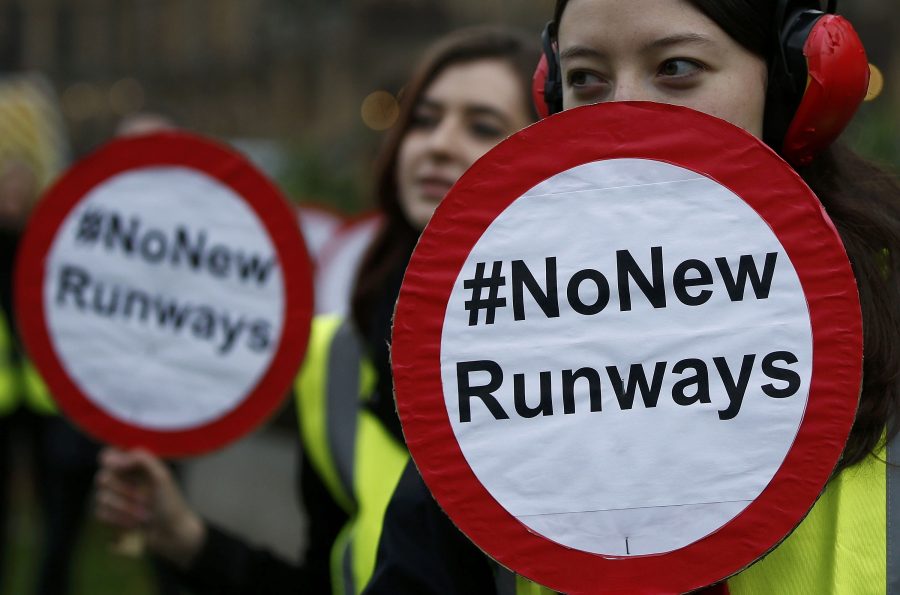 Demonstrators protest on Abbingdon Green before the government's announcement on airport expansion, in London