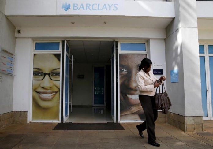 A woman walks from a banking hall within the Barclays Bank Kenya head offices in the capital Nairobi