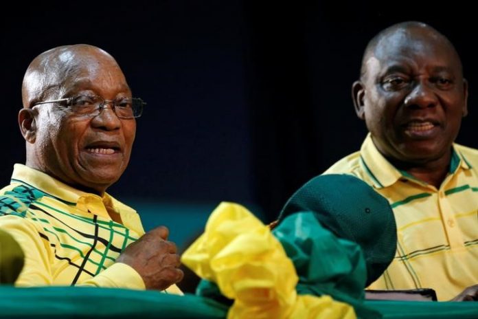 President of South Africa Jacob Zuma sits next to his deputy Cyril Ramaphosa at the 54th National Conference of the ruling African National Congress (ANC) at the Nasrec Expo Centre in Johannesburg
