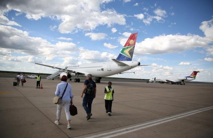 Passengers board a South African Airways the capital aircraft t the Hosea Kutako International Airport, outside Windhoek in Namibia