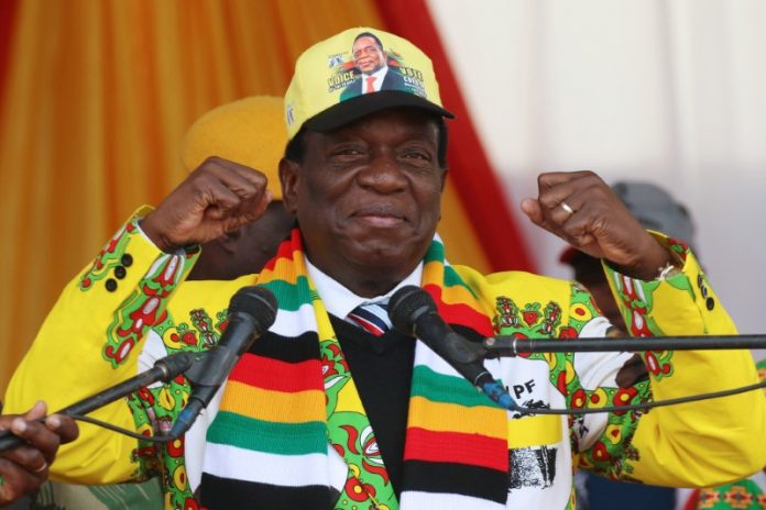 President Emmerson Mnangagwa greets supporters of his ruling ZANU PF party gather for an election rally in Chinhoyi