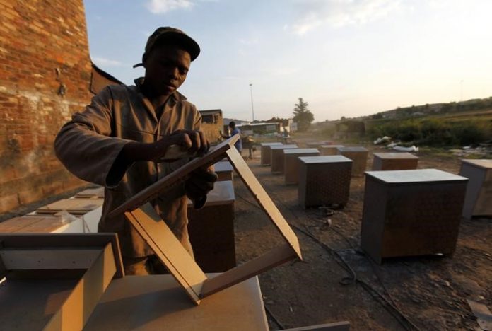 A carpenter makes cupboards to be sold in Soweto