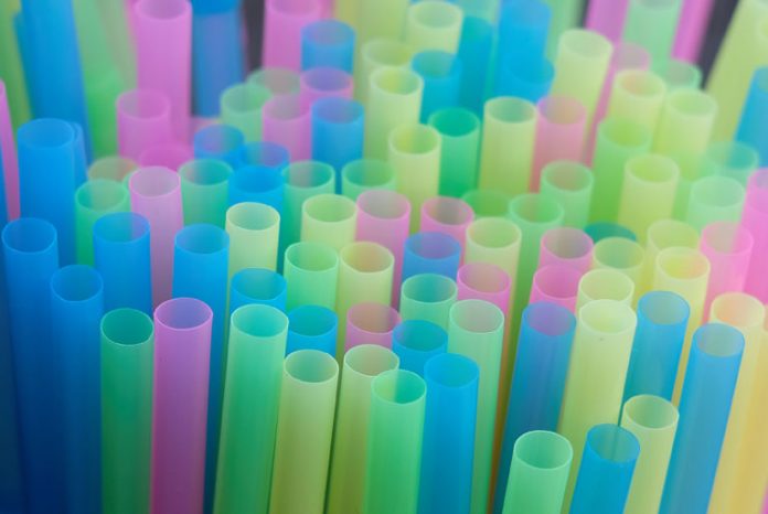 FILE PHOTO: Drinking straws protrude from a glass in a illustration picture in Loughborough