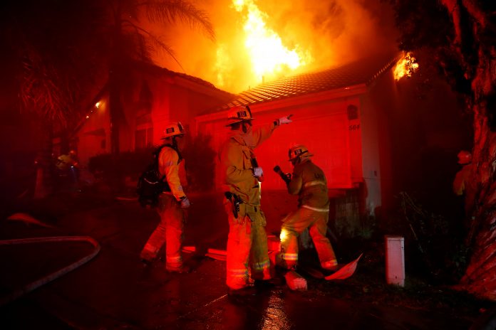 Firefighters battle flames overnight during a wildfire that burned dozens of homes in Thousand Oaks