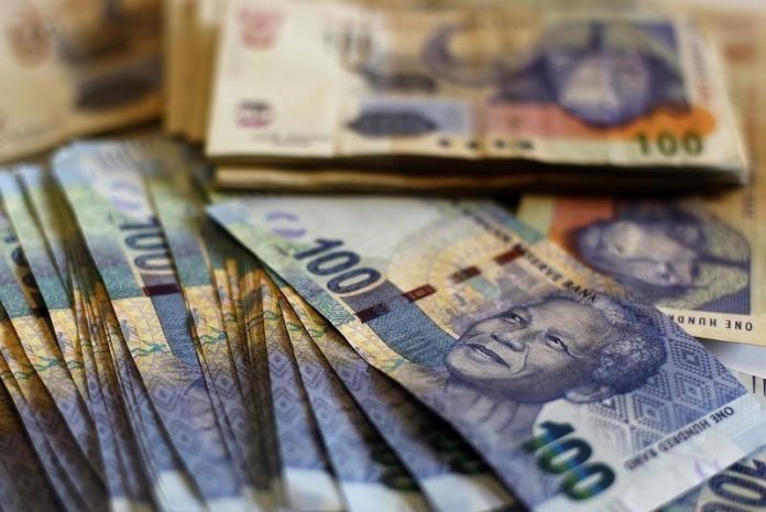 New South African bank notes featuring an image of former South African President Nelson Mandela are displayed at an office in Johannesburg