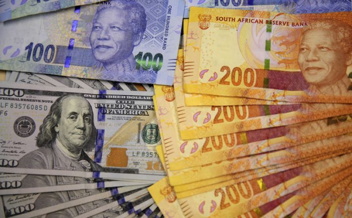 Photo illustration of South African bank notes displayed next to the American dollar notes in Johannesburg