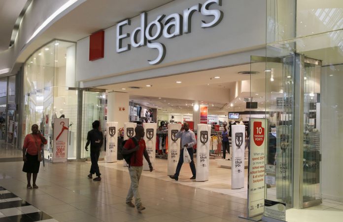 Shoppers walk past an Edgars store at a shopping centre in Soweto, southwest of Johannesburg
