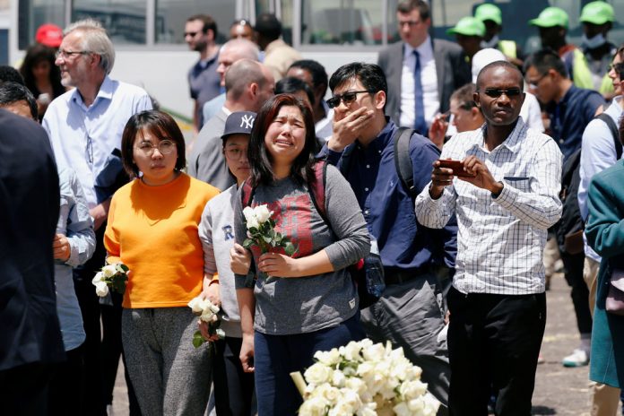 Chinese family and friends mourn victims of the Ethiopian Airlines Flight ET 302 plane crash during a commemoration ceremony at the scene of the crash, near the town of Bishoftu, southeast of Addis Ababa