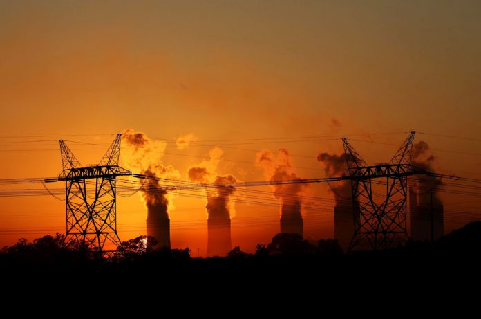 FILE PHOTO: Electricity pylons are seen in front of the cooling towers at Eskom's Lethabo thermal power station eskom loadshedding