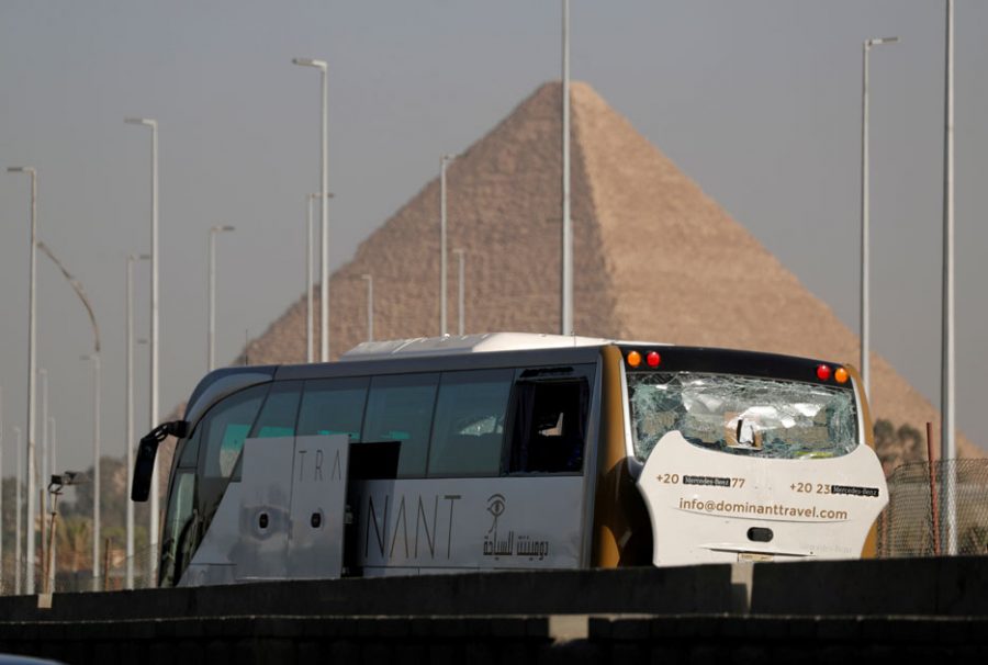 A damaged bus is seen at the site of a blast near a new museum being built close to the Giza pyramids in Cairo