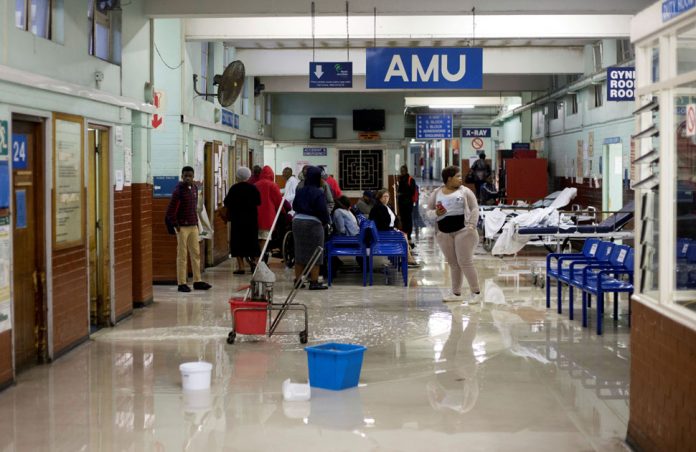 FILE PHOTO: Cleaners mop up water at King Edward VIII Hospital during a storm in Durban