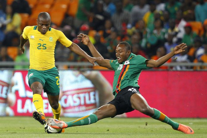 Zambia's Stoppila Sunzu challenges Tokelo Rantie of South Africa during the Nelson Mandela Challenge at Soccer city outside Soweto