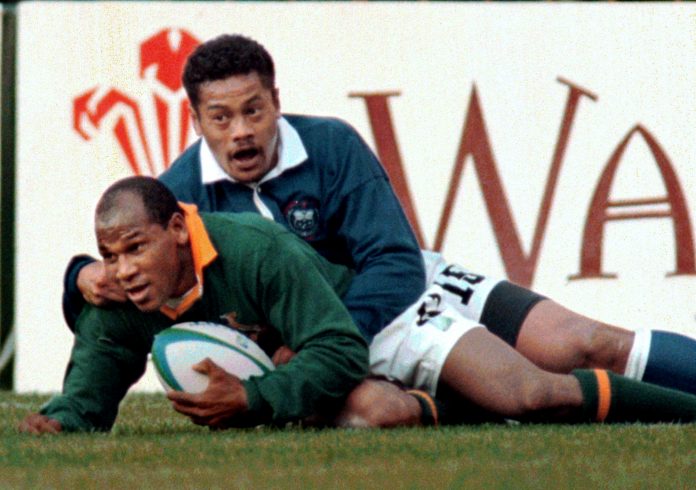 FILE PHOTO: South African left wing Chester Williams scores the second try for his team June 10 during the quart..
