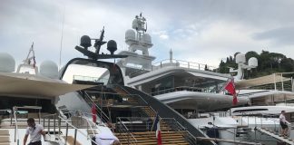 Deck hands working on yachts in Portofino, Italy