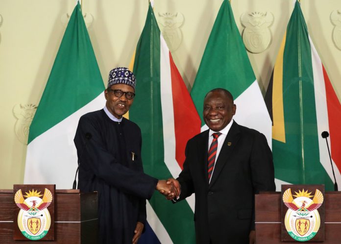 Nigeria's President Muhammadu Buhari shakes hands with his South African counterpart Cyril Ramaphosa
