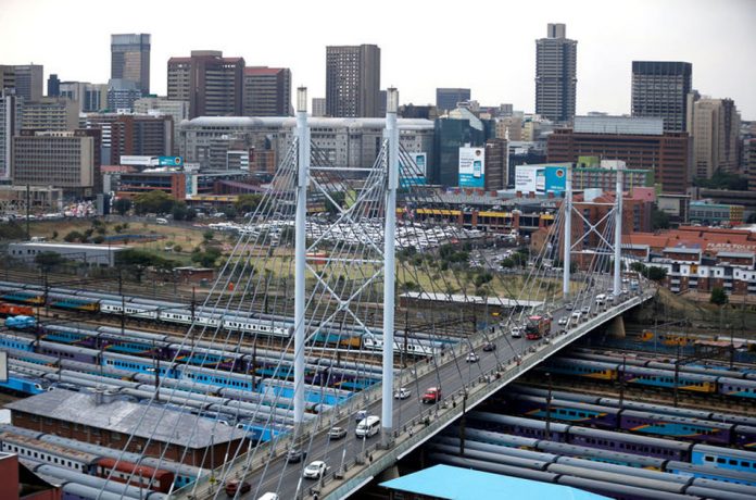 The city of Johannesburg over looks the Mandela bridge, with trains parked underneath, in Johannesburg cyber crime affects south africa