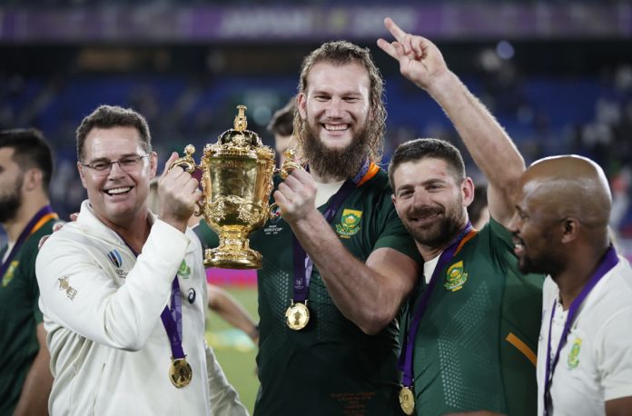 South Africa head coach Rassie Erasmus and South Africa's RG Snyman pose with the Webb Ellis Cup they celebrate winning the world cup final.