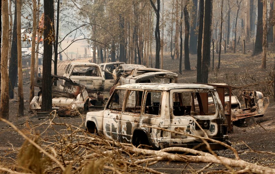 A cluster of burnt out cars sit at a property at Rainbow Flat