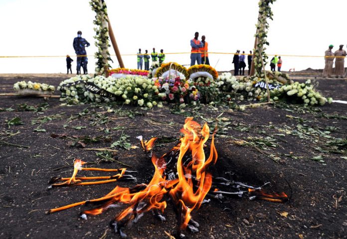 Candle flames burn during a commemoration ceremony for the victims at the scene of the Ethiopian Airlines Flight ET 302 plane crash, near the town Bishoftu