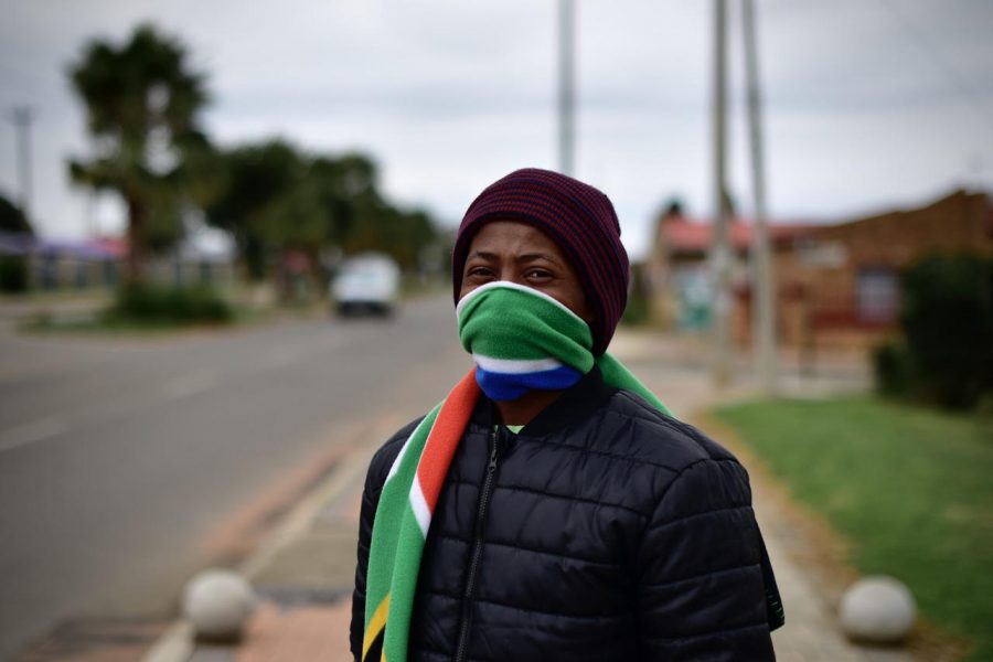 Pedestrian dons improvised mask whilst passing the clinic Pedestrian dons improvised mask whilst passing the clinic