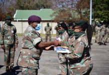 Lieutenant General R. Maphwanya handing over hygiene parcels to female officers, after which a near 324 female enlistees line up – Doornkop, Johannesburg.