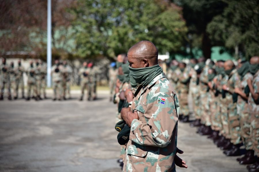Soldiers remove their berets for a prayer by the Chaplain General.