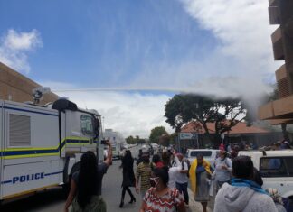 Hundreds of people queueing outside the SASSA offices in Bellville were doused with water by police after they were told to observe social distance on Friday. Photo: Mary-Anne Gontsana