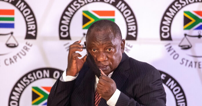 South African President Cyril Ramaphosa adjusts his mask as he appears to testify before the Zondo Commission of Inquiry into State Capture in Johannesburg, South Africa, April 28, 2021. Themba Hadebe/Pool via REUTERS