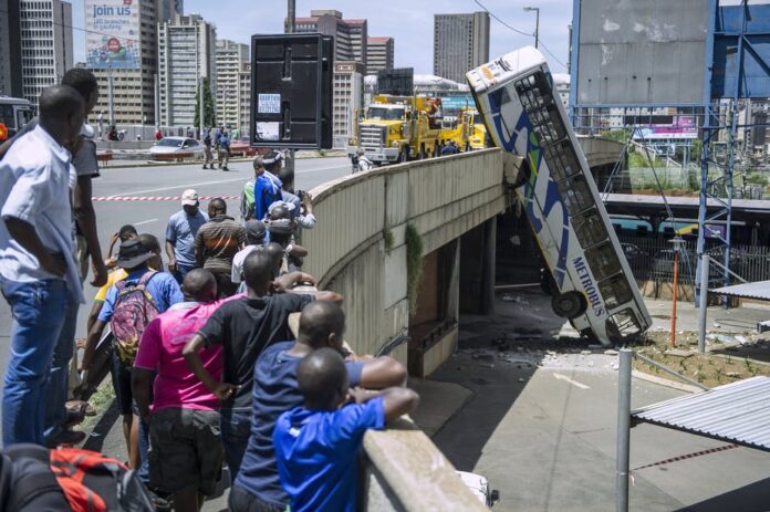 car accidents South Africa Onlookers gather on Queen Elizabeth bridge to look at a public transport bus that drove over the side of the bridge in Johannesburg, South Africa. Mujahid Safodien/AFP via Getty Images