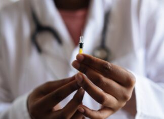 vaccineblackdrholdingsyringe