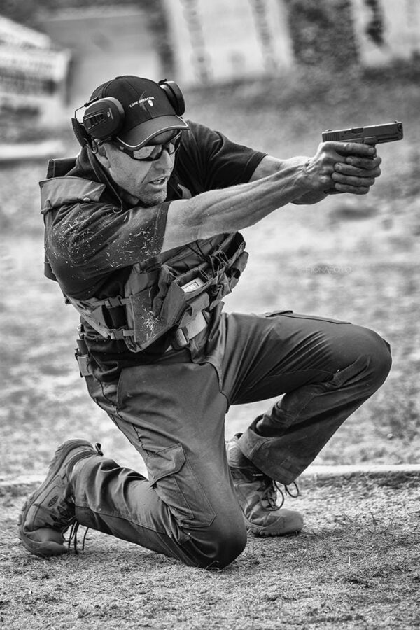 Driver Leo who runs his own company teaching people how to fire guns and fight back demonstrates his gun skills at a teaching class