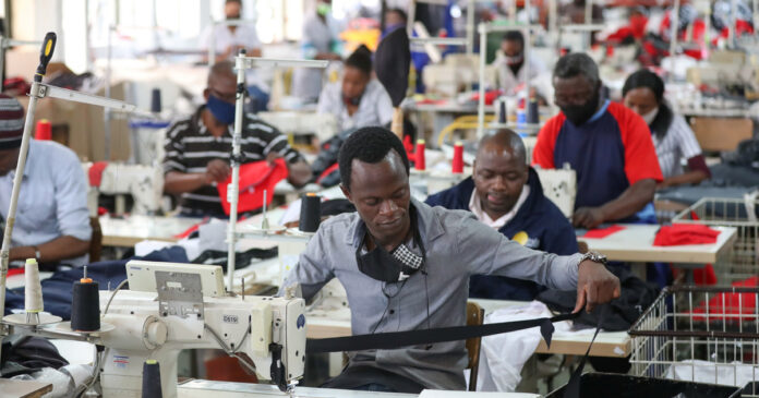 South-African-factory-workers-rise-2021-05-05T075549Z_1_LYNXMPEH440B6-OZABS_RTROPTP_4_OZABS-UK-SAFRICA-ECONOMY-PMI-th People work at ''The Faktory