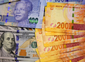 South African bank notes featuring images of former South African President Nelson Mandela (R) are displayed next to the American dollar notes in this photo illustration in Johannesburg , file. REUTERS/Siphiwe Sibeko
