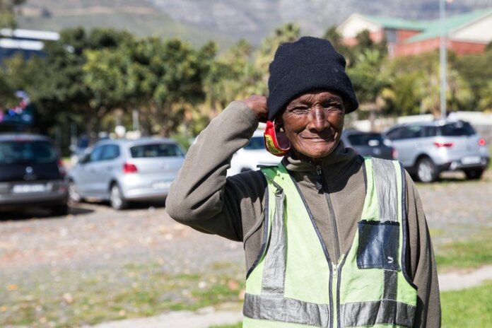 Last year GroundUp photographed “Auntie Kar”, a car guard at the Buitenkant Street Fruit & Veg City. Nearly 60, she has spent her entire adult life on the street. Photo: Ashraf Hendricks