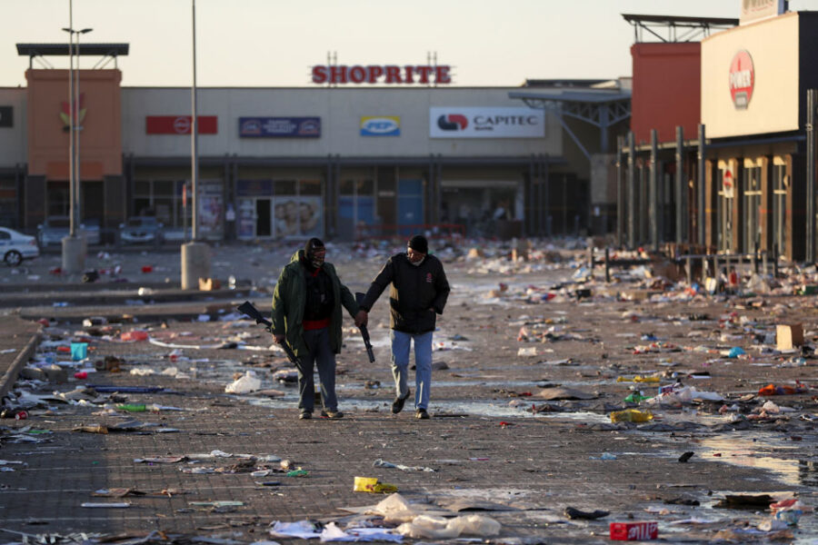 Members of a private security walk at a looted shopping mall as the country deploys army to quell unrest linked to the jailing of former South African President Jacob Zuma, in Vosloorus, South Africa, July 14, 2021. REUTERS/Siphiwe Sibeko
