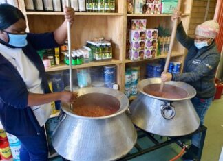 Marshay Jantjies and Bianca Dumba prepare to serve the hot dish to nearly 700 people outside the pharmacy on Thursday morning.